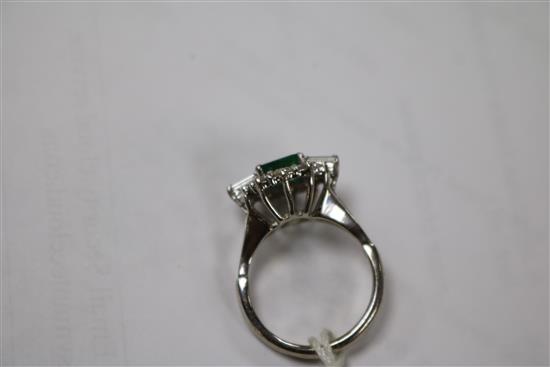 A white metal, emerald and diamond cluster dress ring, size M.